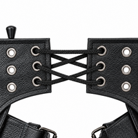 Close-up of the adjustable lace-up back of YMGA black leather motorcycle chaps, featuring braided black laces, metal eyelets and textured leather.